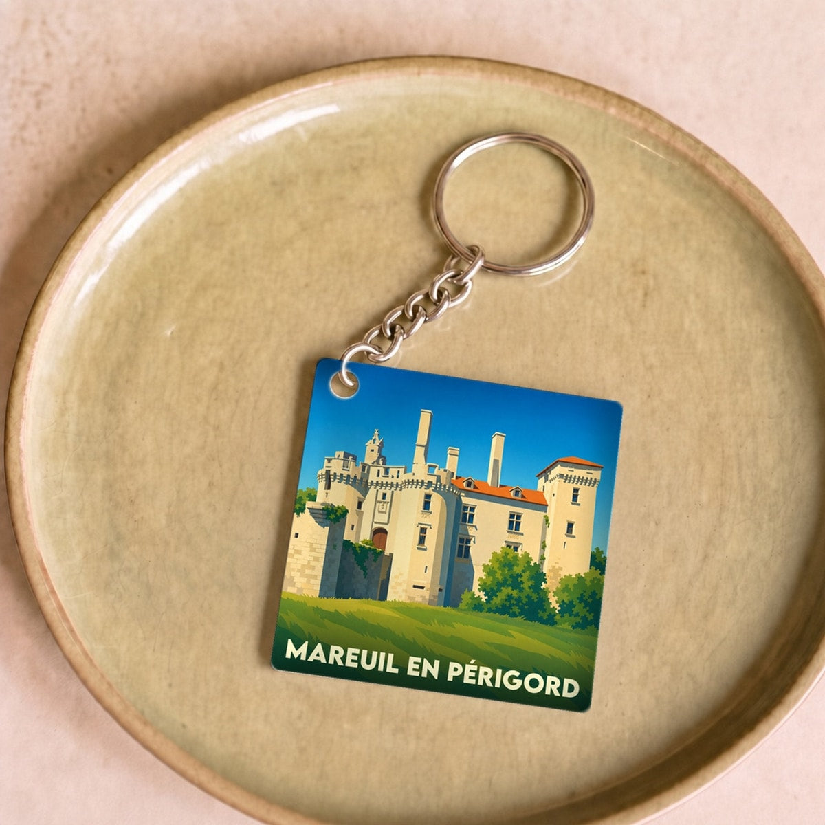 Porte-clés souvenir de la ville de Mareuil en Périgord avec une illustration stylisée de son château.