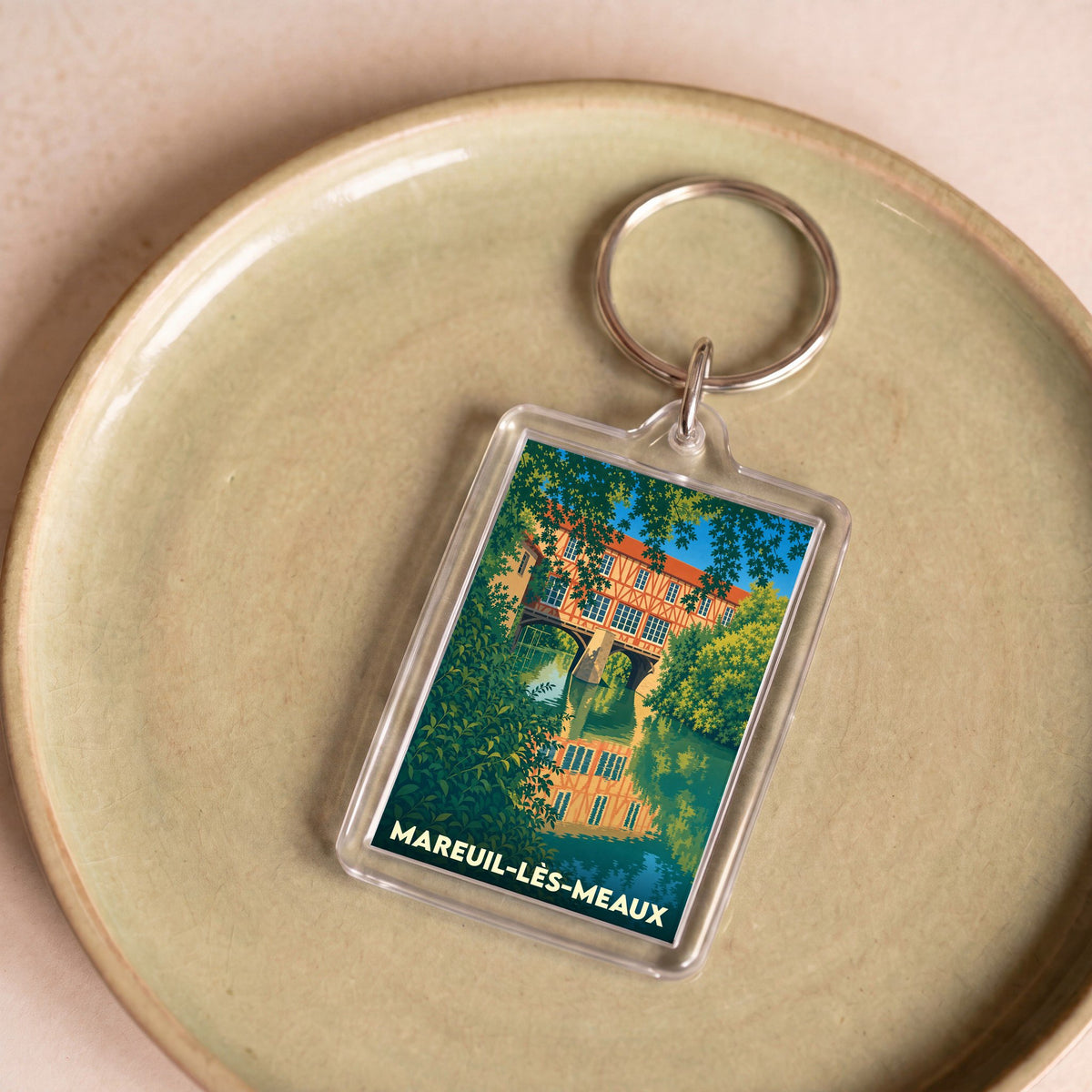 Porte-clés souvenir de la ville de Mareuil-lès-Meaux avec une illustration stylisée.