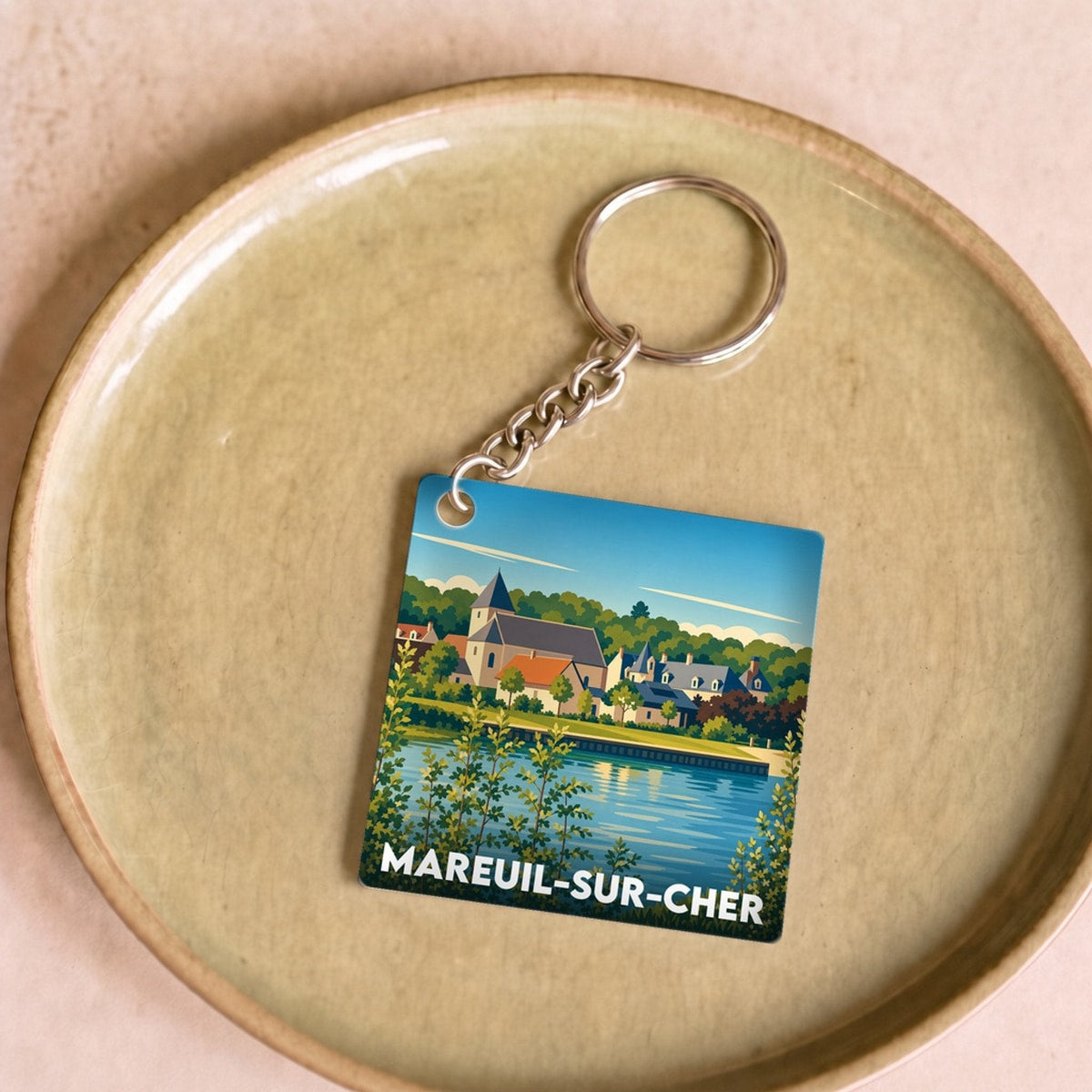 Porte-clés souvenir de la ville de Mareuil-sur-Cher avec une illustration stylisée.