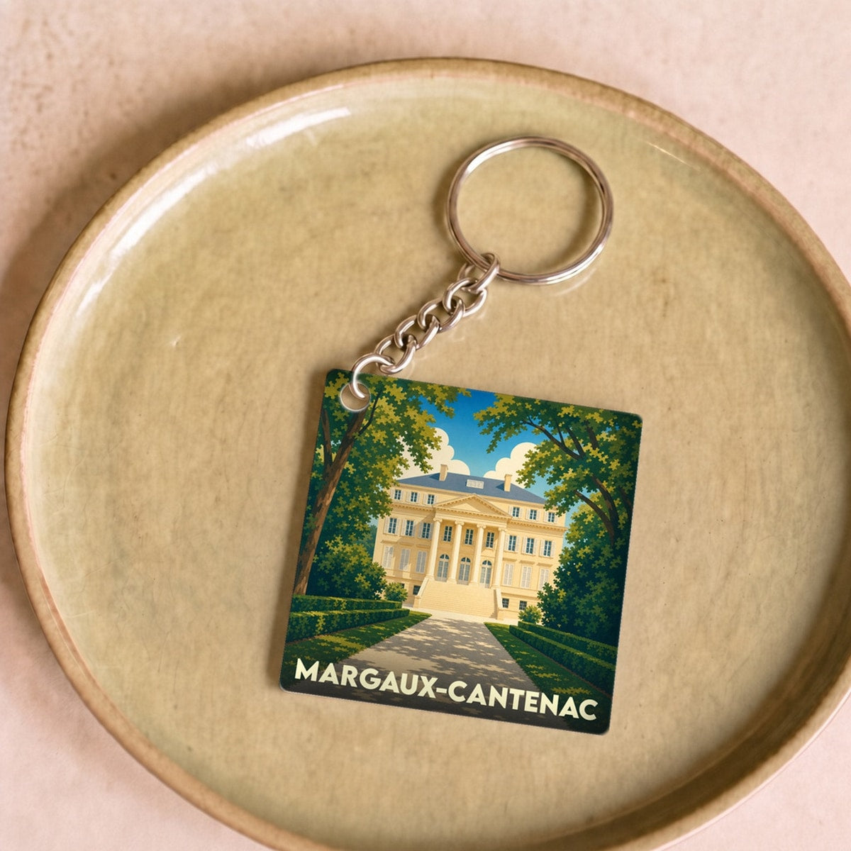 Porte-clés souvenir de la ville de Margaux-Cantenac avec une illustration stylisée d'un château.