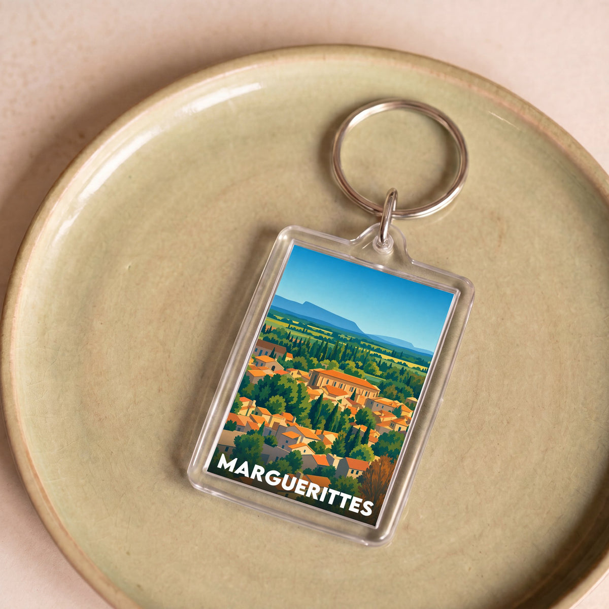 Porte-clés souvenir de la ville de Marguerittes avec une illustration stylisée.