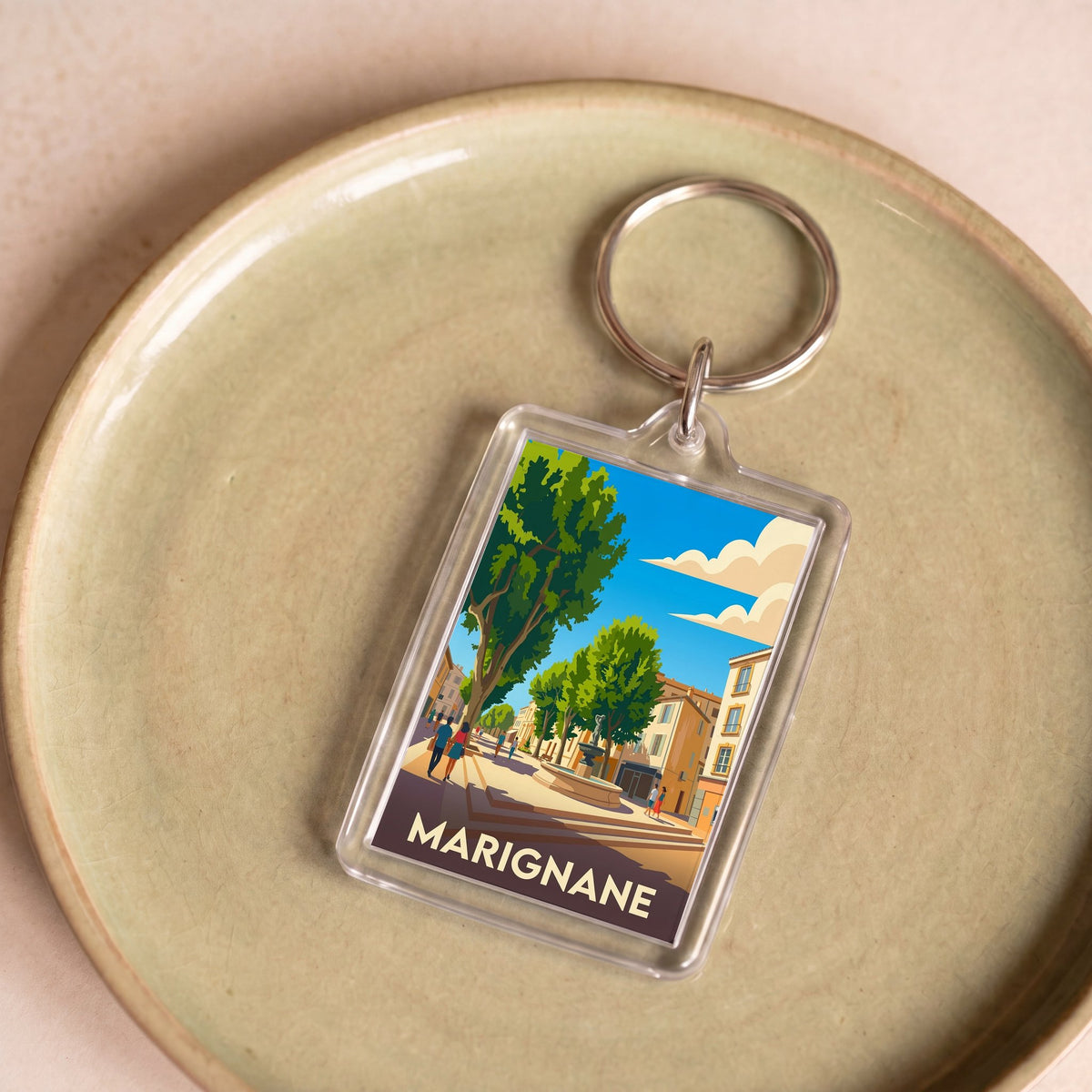 Porte-clés souvenir de la ville de Marignane avec une illustration stylisée.