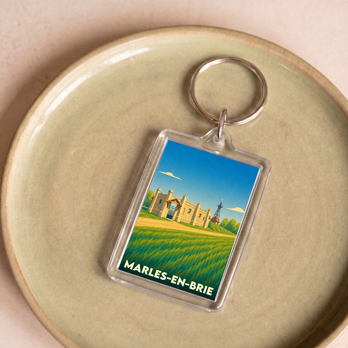 Porte-clés souvenir de la ville de Marles-en-Brie avec une illustration stylisée.