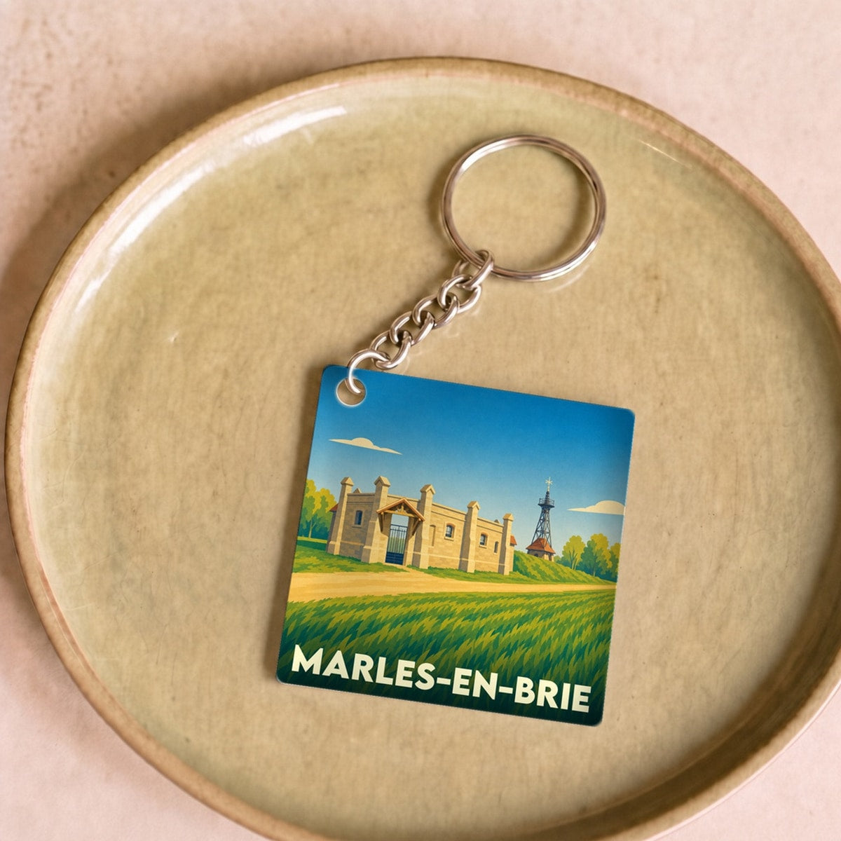 Porte-clés souvenir de la ville de Marles-en-Brie avec une illustration stylisée.