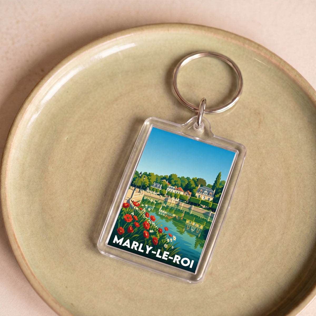 Porte-clés souvenir de la ville de Marly-le-Roi avec une illustration stylisée.
