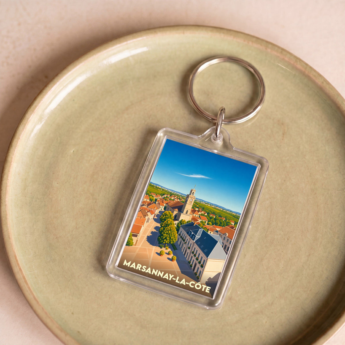 Porte-clés souvenir de la ville de Marsannay-la-Côte avec une illustration stylisée.