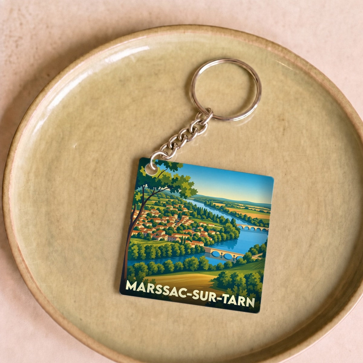 Porte-clés souvenir de la ville de Marssac-sur-Tarn avec une illustration stylisée.