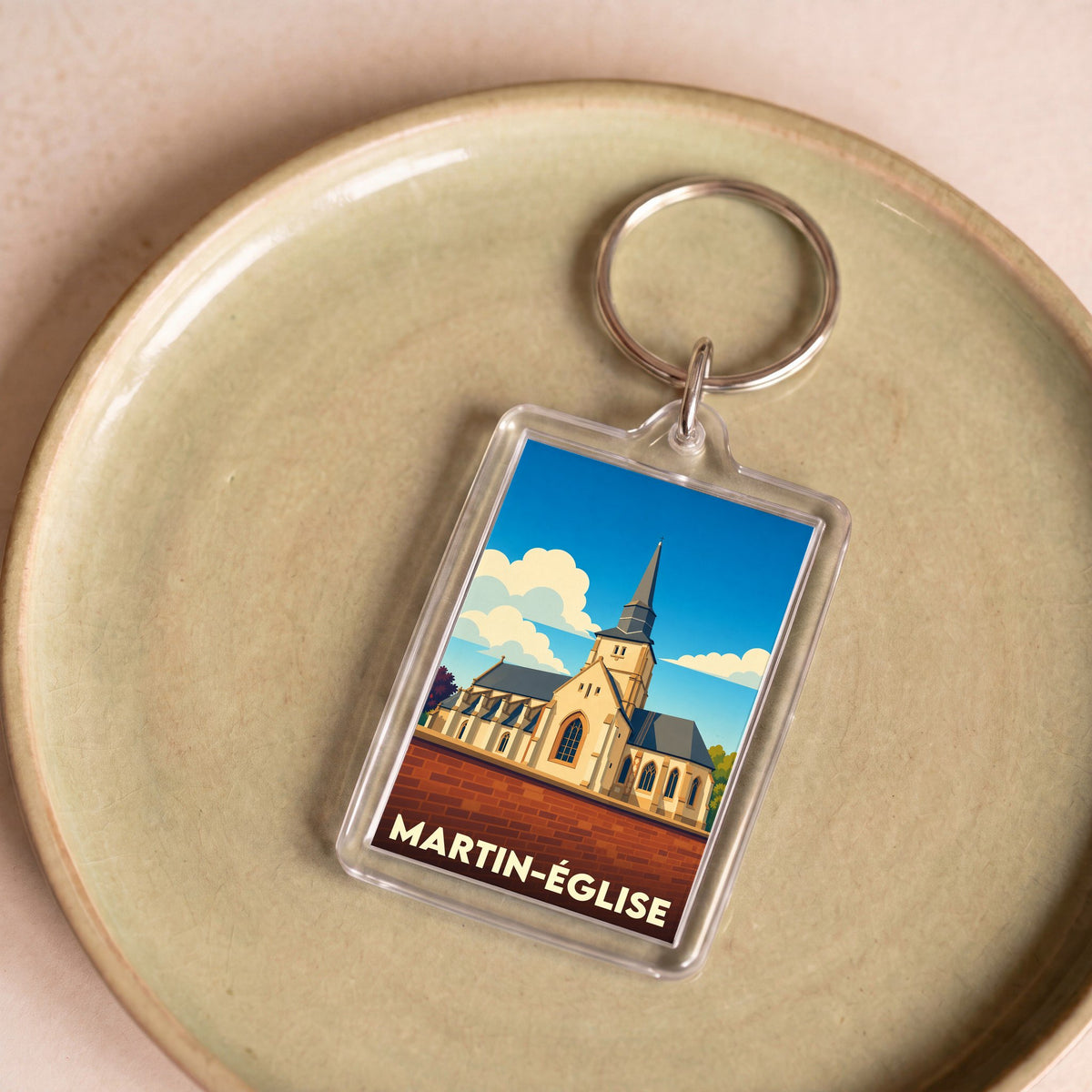 Porte-clés souvenir de la ville de Martin-Église avec une illustration stylisée de son église.