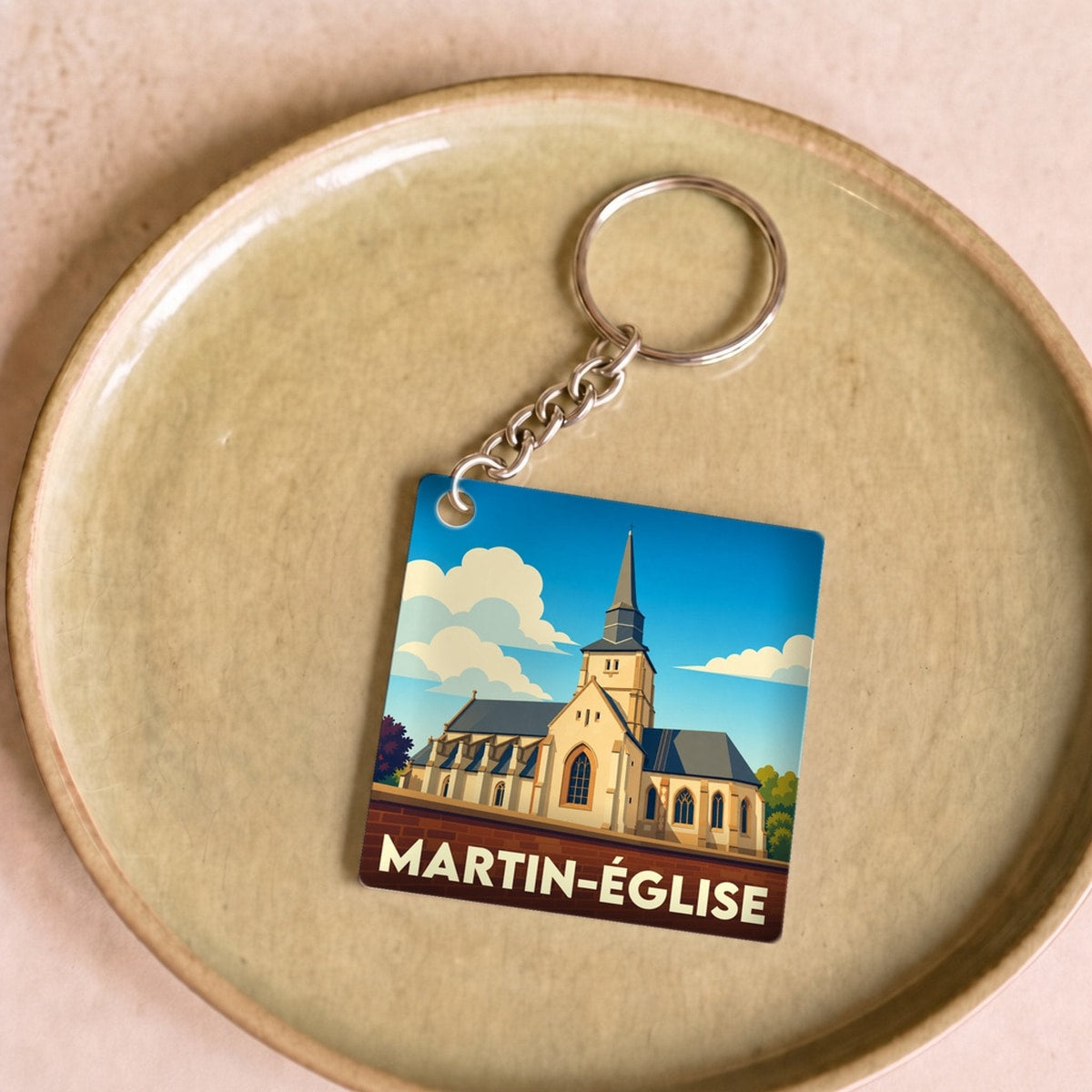 Porte-clés souvenir de la ville de Martin-Église avec une illustration stylisée de son église.