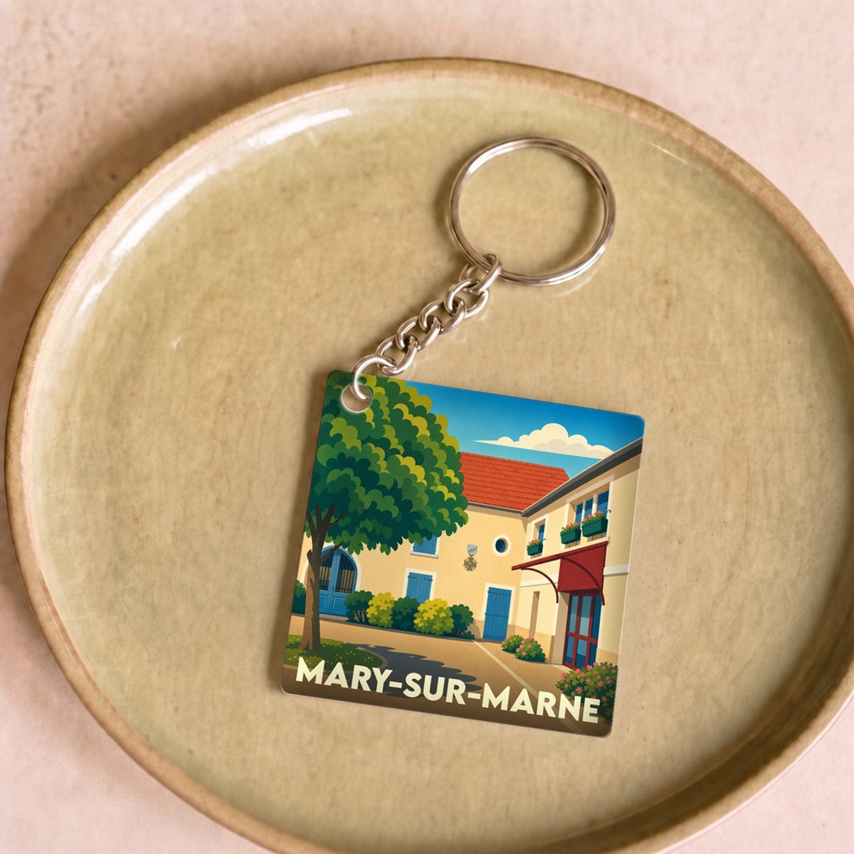 Porte-clés souvenir de la ville de Mary-sur-Marne avec une illustration stylisée.