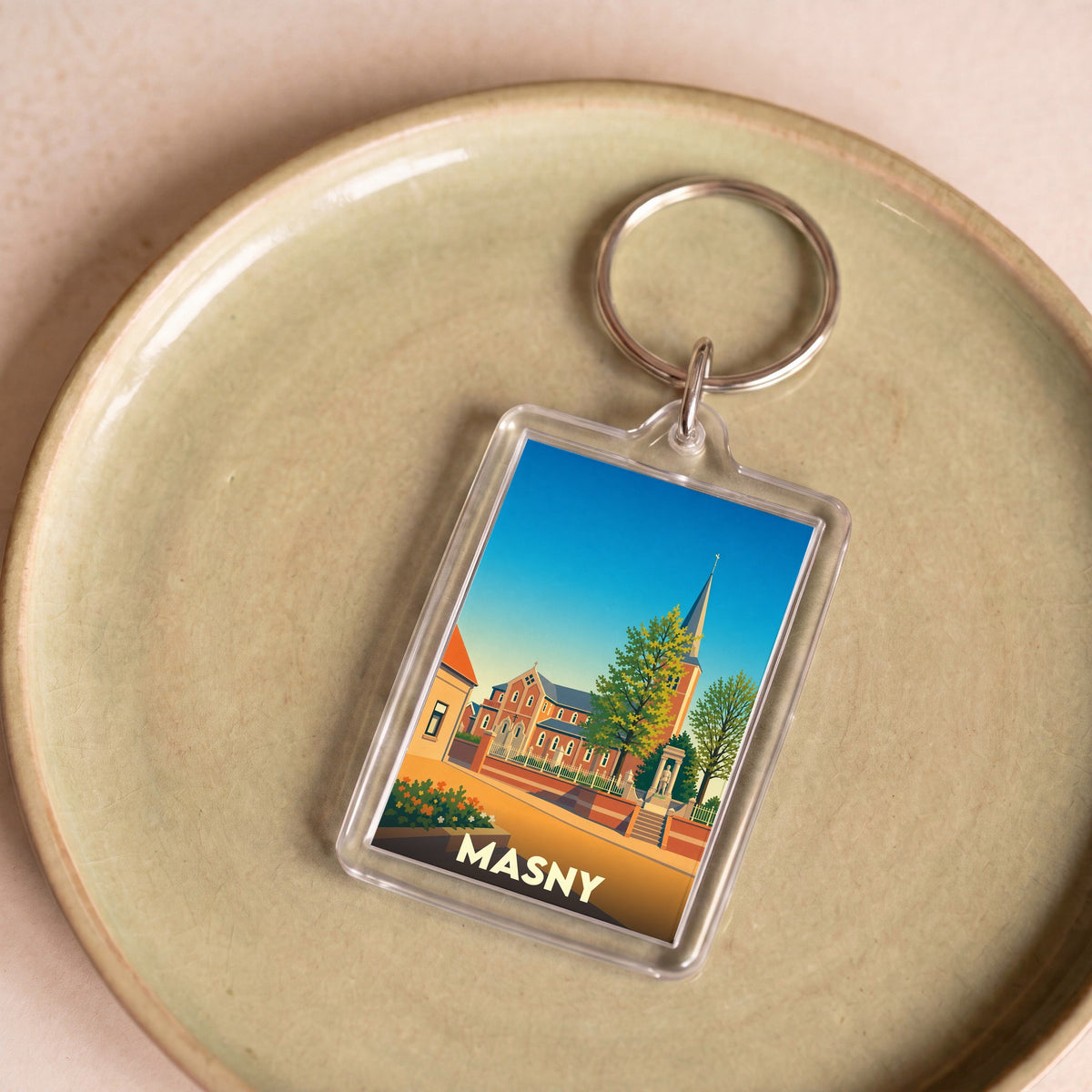 Porte-clés souvenir de la ville de Masny avec une illustration stylisée.