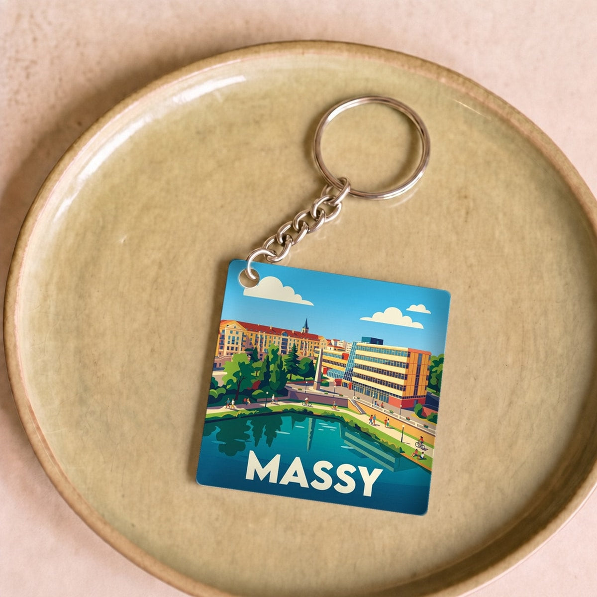 Porte-clés souvenir de la ville de Massy avec une illustration stylisée de son paysage urbain.