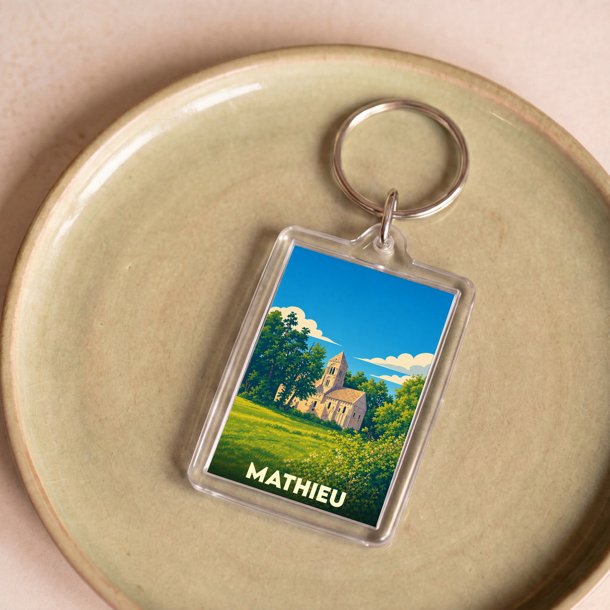 Porte-clés souvenir de la ville de Mathieu avec une illustration stylisée.