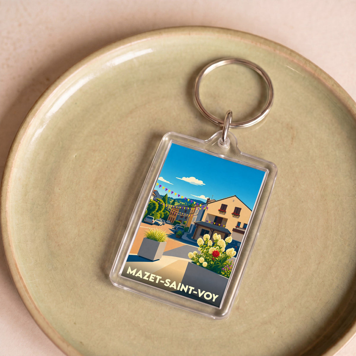 Porte-clés souvenir de la ville de Mazet-Saint-Voy avec une illustration stylisée.