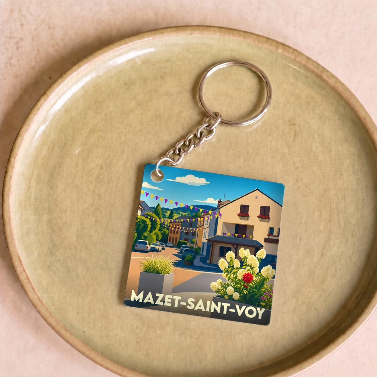 Porte-clés souvenir de la ville de Mazet-Saint-Voy avec une illustration stylisée.