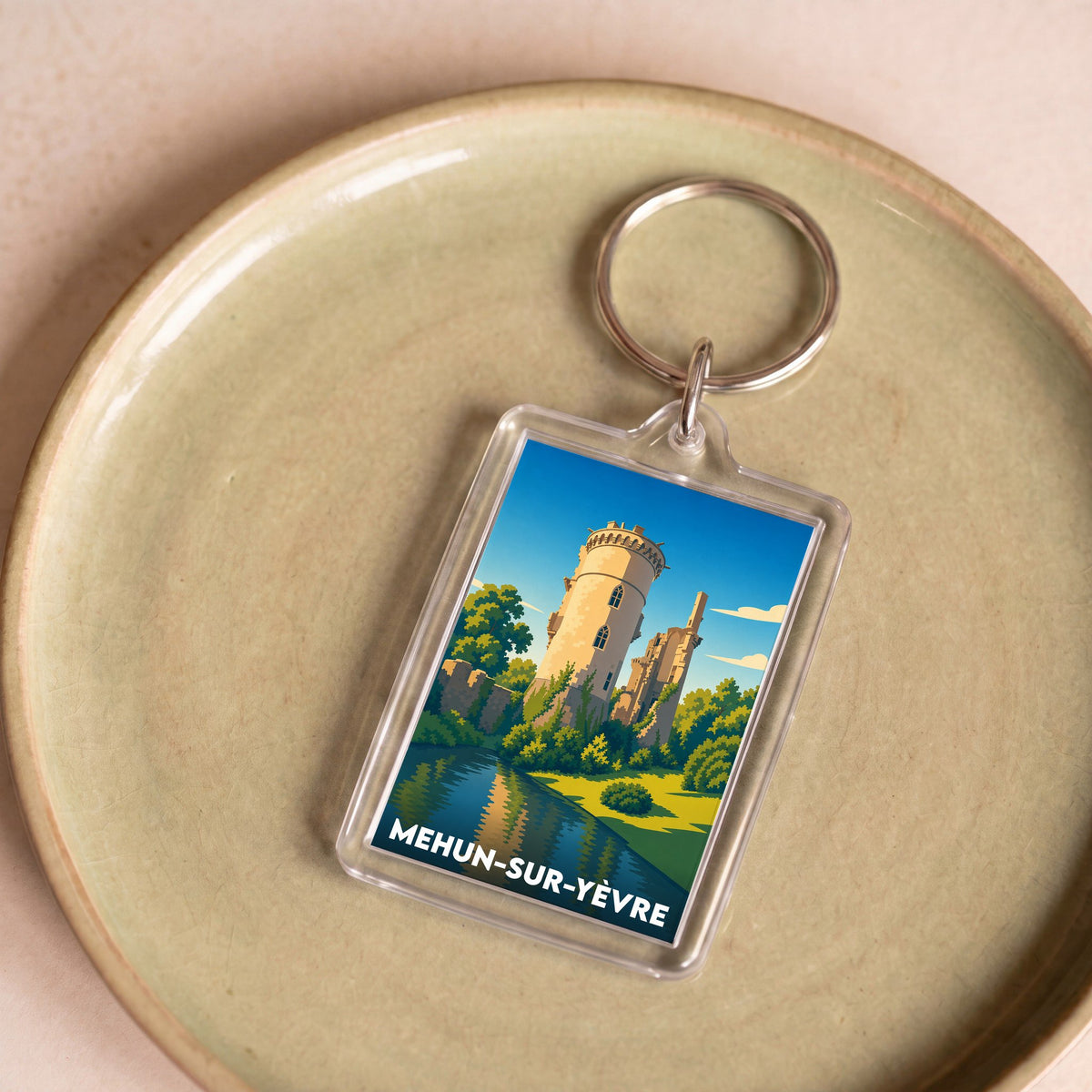 Porte-clés souvenir de la ville de Mehun-sur-Yèvre avec une illustration stylisée de son château.