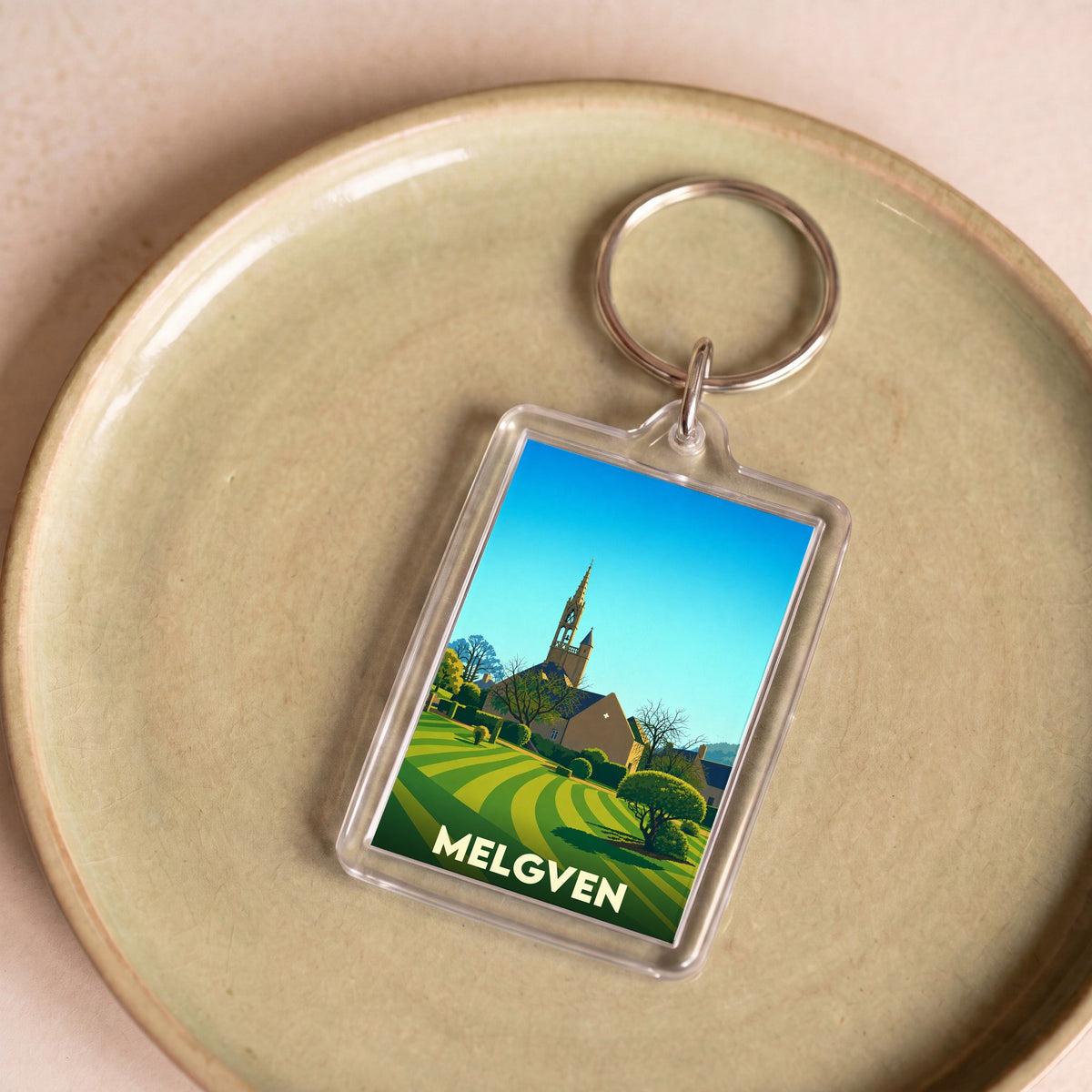 Porte-clés souvenir de la ville de Melgven avec une illustration stylisée.