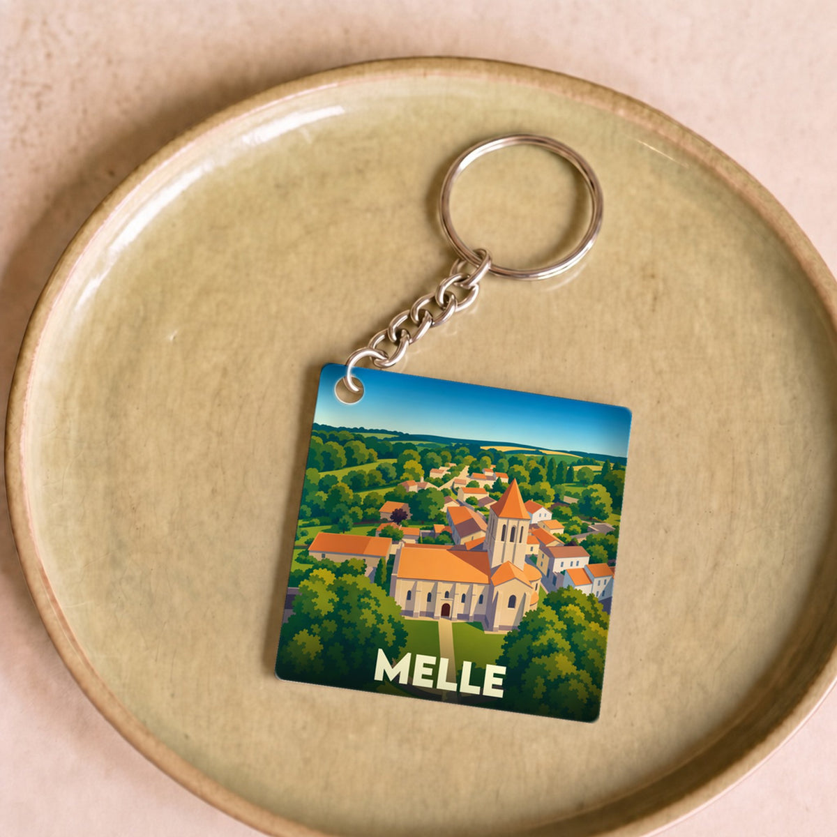 Porte-clés souvenir de la ville de Melle avec une illustration stylisée.