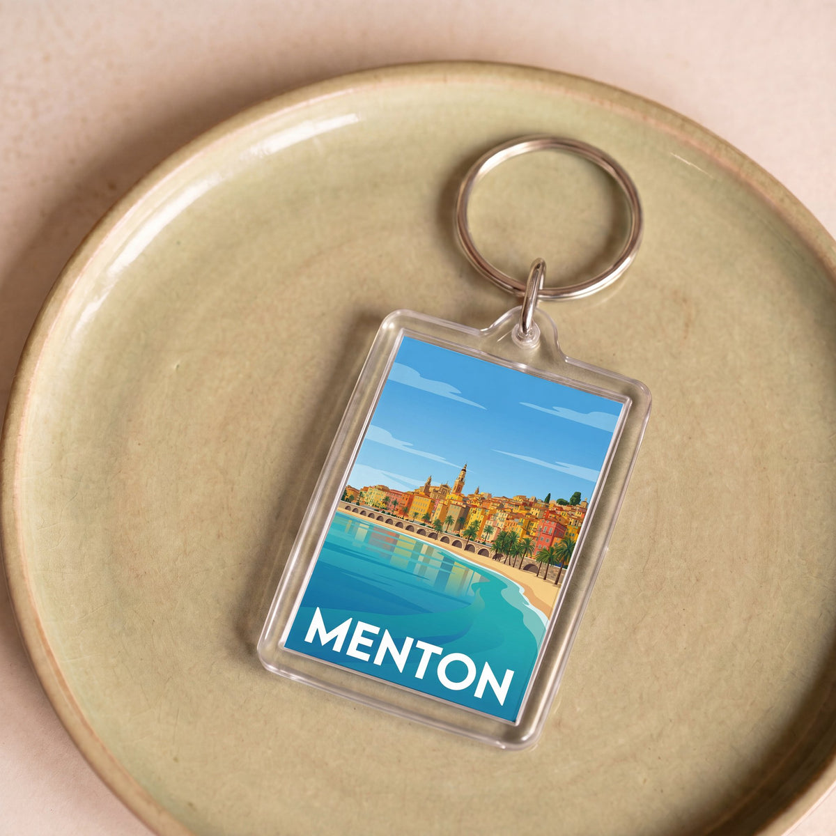 Porte-clés souvenir de la ville de Menton avec une illustration stylisée et colorée.