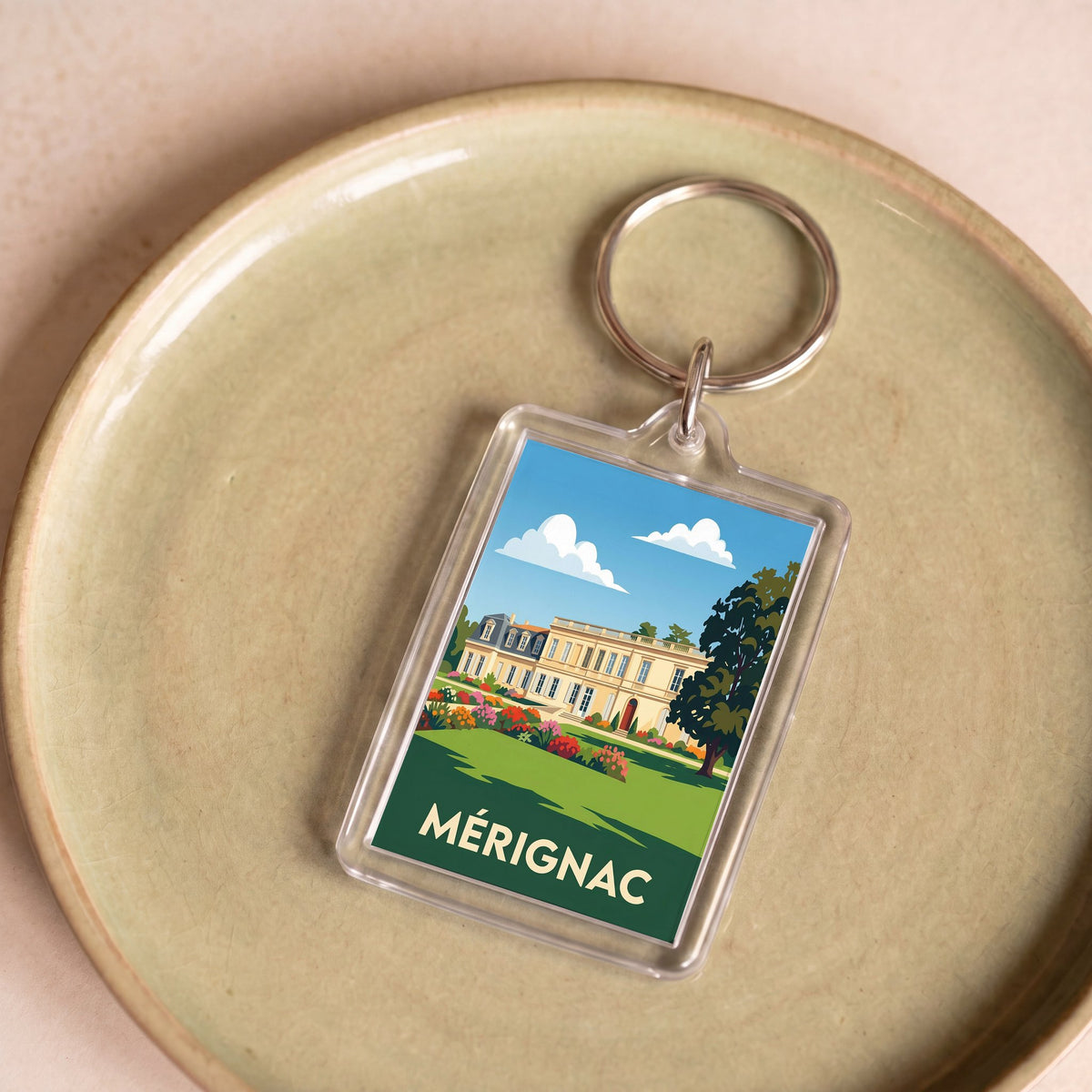 Porte-clés souvenir de la ville de Mérignac avec une illustration stylisée.