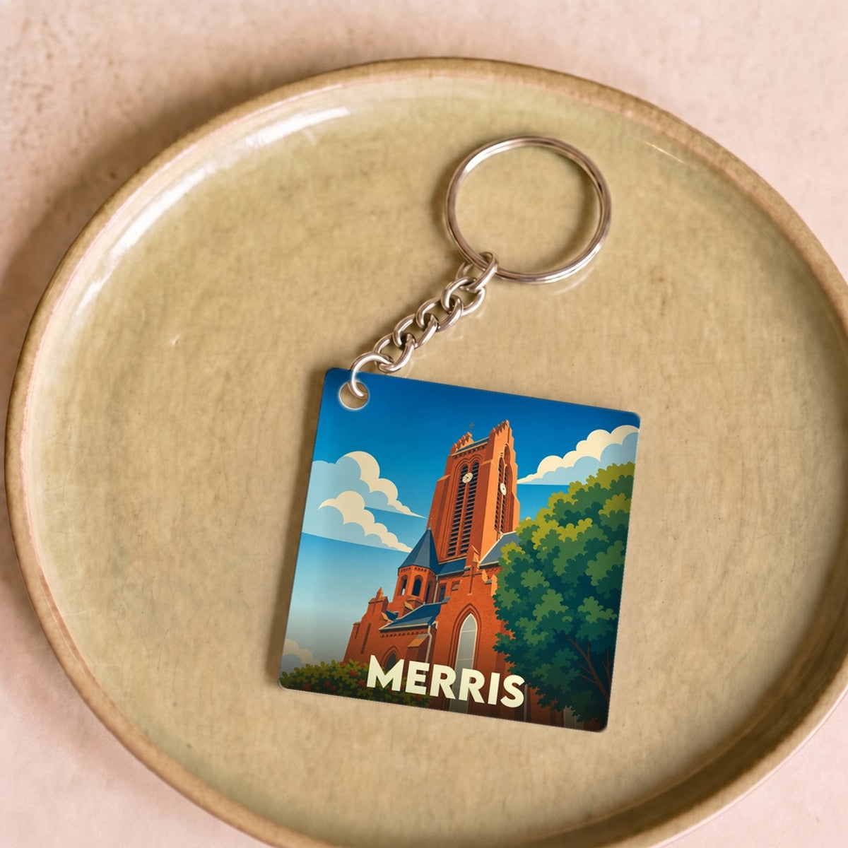 Porte-clés souvenir de la ville de Merris avec une illustration stylisée de son église.