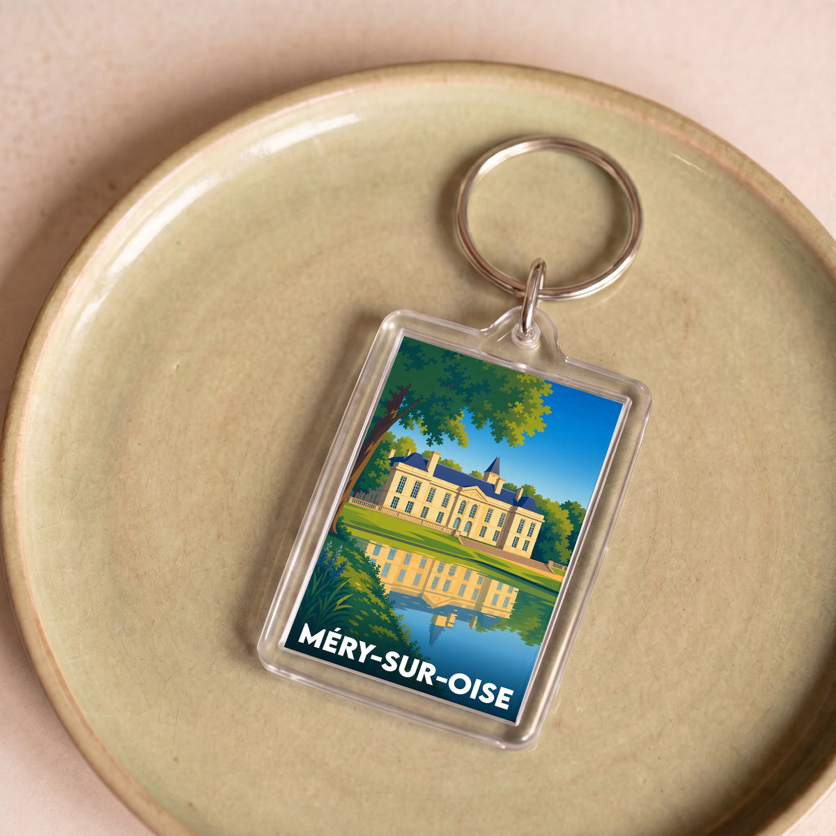 Porte-clés souvenir de la ville de Méry-sur-Oise avec une illustration stylisée de son château.
