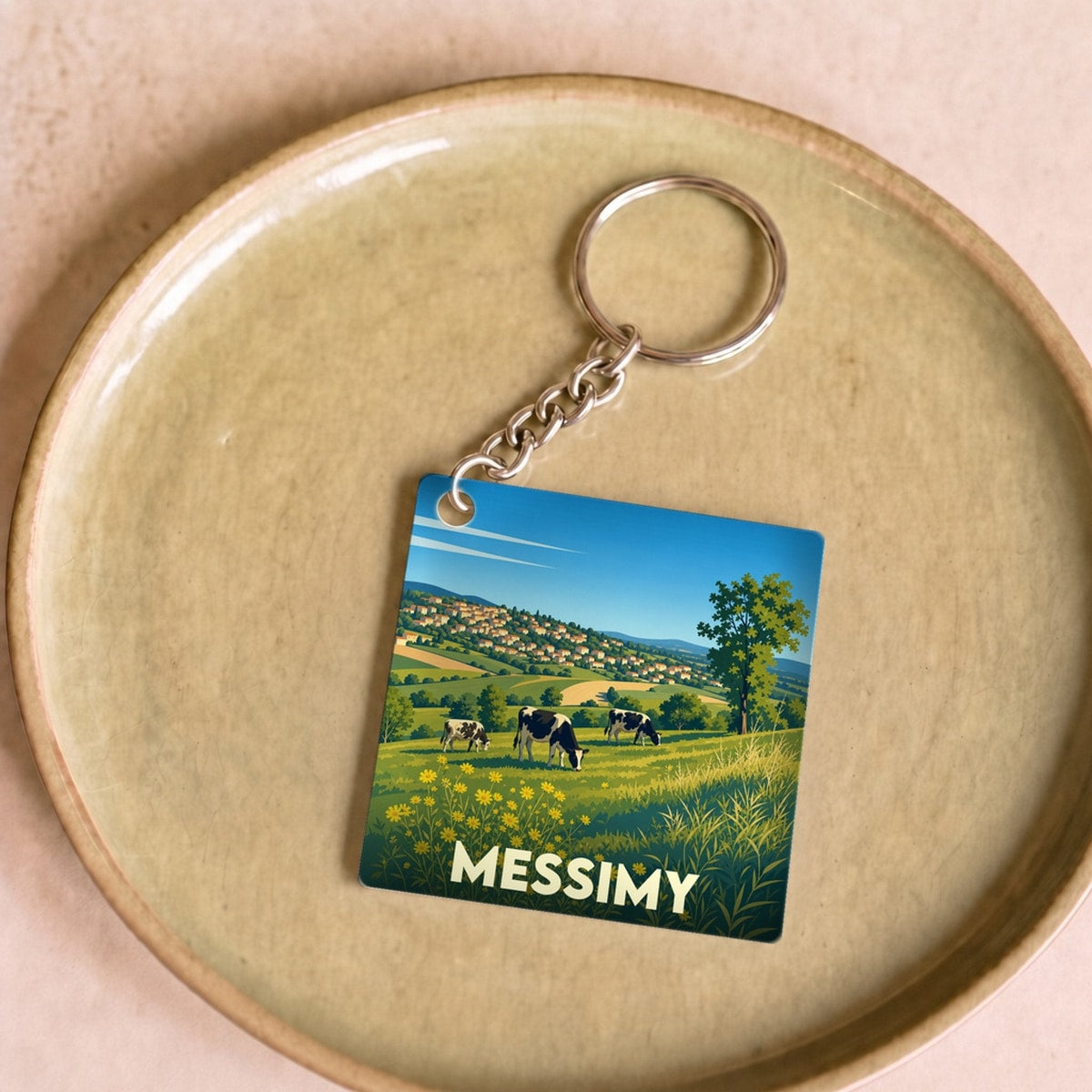 Porte-clés souvenir de la ville de Messimy avec une illustration champêtre stylisée.
