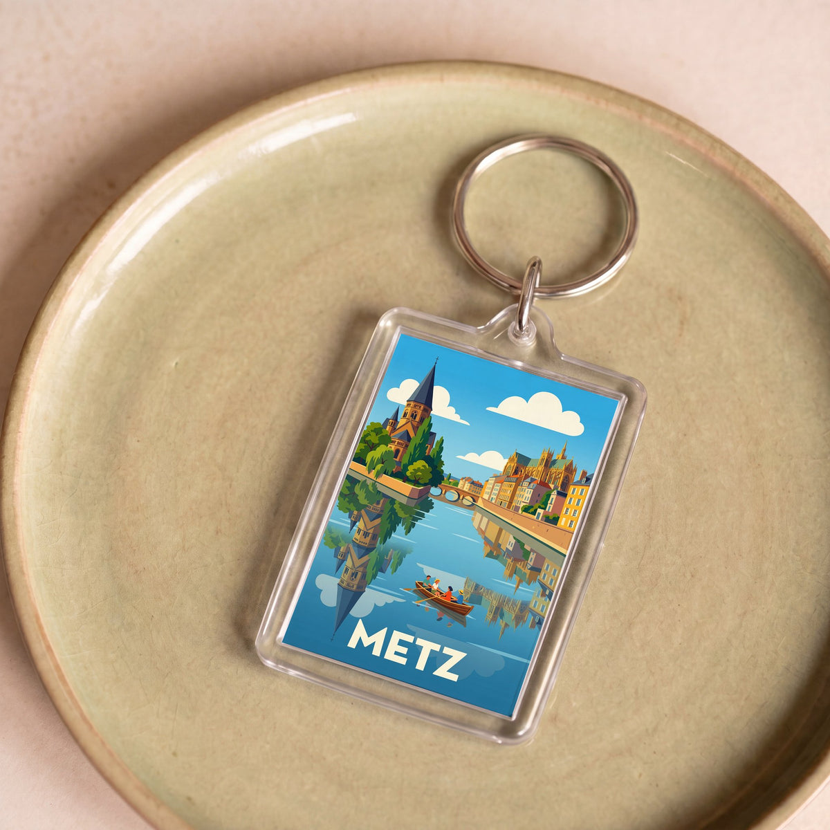 Porte-clés souvenir de la ville de Metz avec une illustration stylisée.