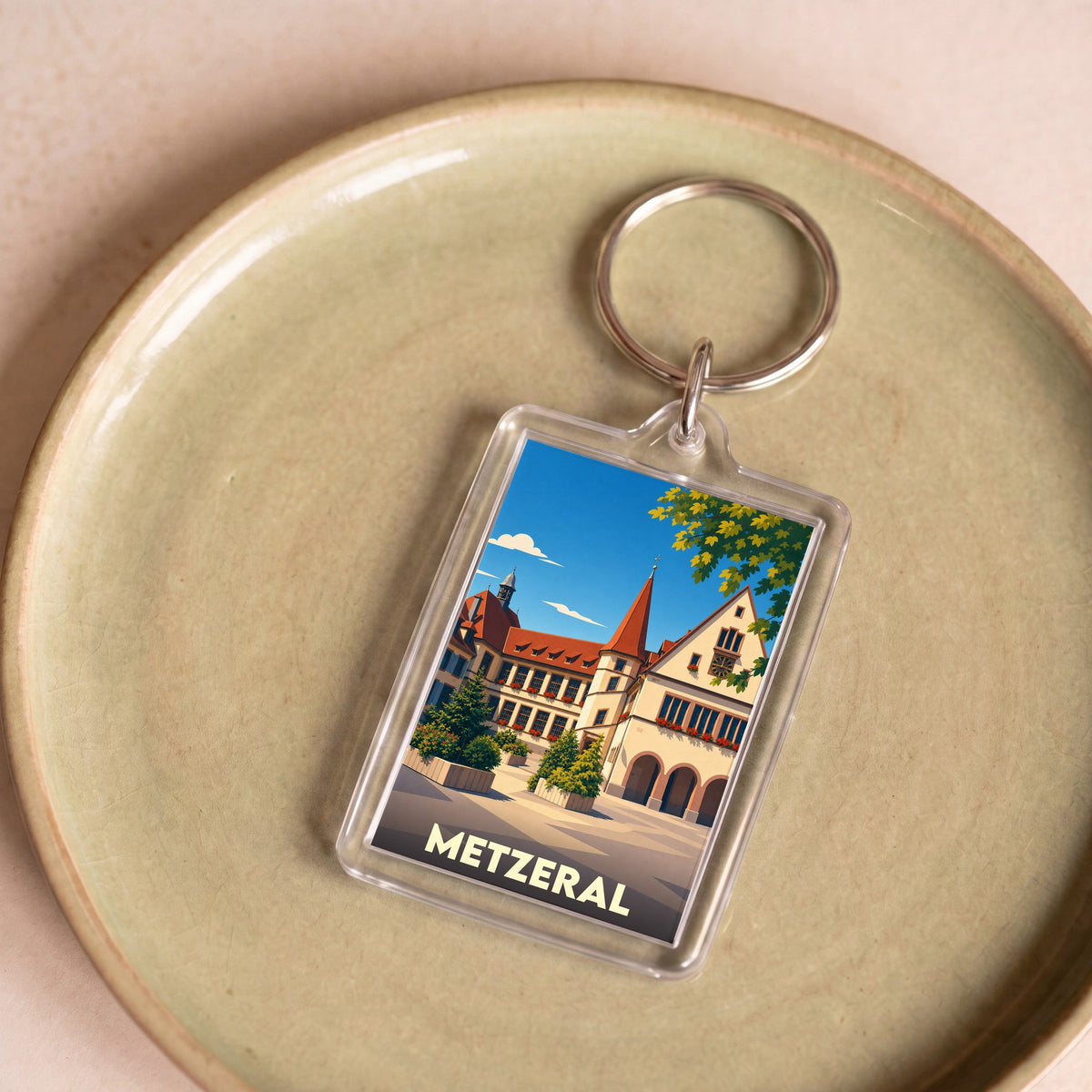 Porte-clés souvenir de la ville de Metzeral avec une illustration stylisée.
