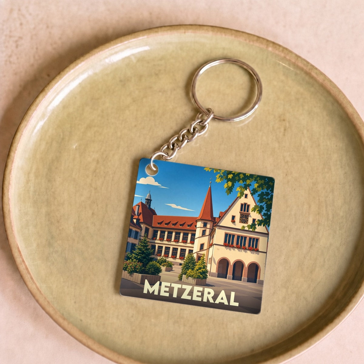 Porte-clés souvenir de la ville de Metzeral avec une illustration stylisée.