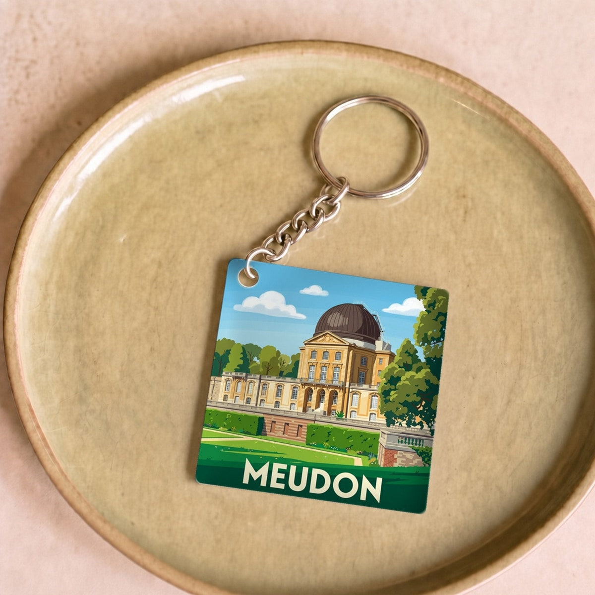 Porte-clés souvenir de la ville de Meudon avec une illustration stylisée de l'observatoire.