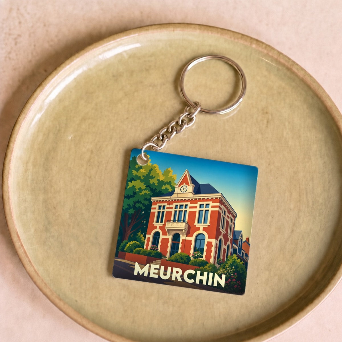 Porte-clés souvenir de la ville de Meurchin avec une illustration stylisée.