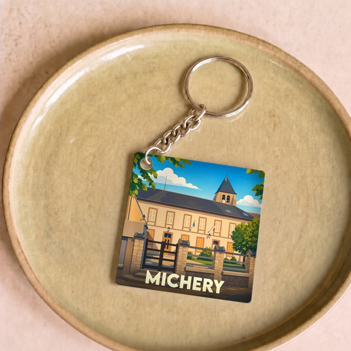 Porte-clés souvenir de la ville de Michery avec une illustration stylisée de sa mairie.
