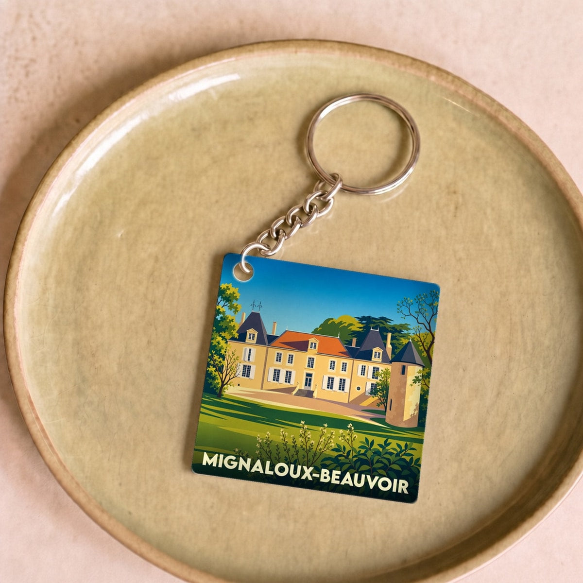 Porte-clés souvenir de la ville de Mignaloux-Beauvoir avec une illustration stylisée.
