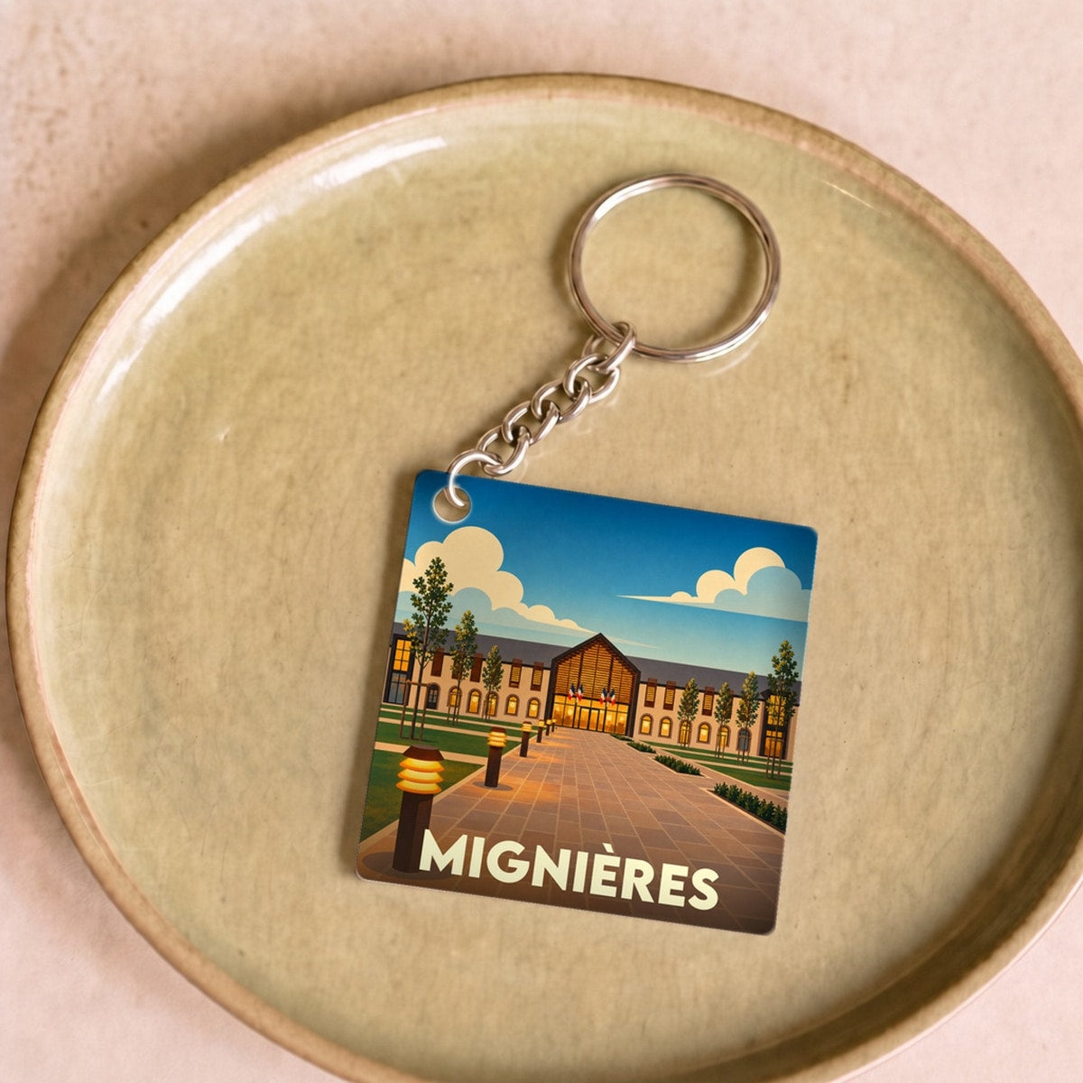 Porte-clés souvenir de la ville de Mignières avec une illustration stylisée.