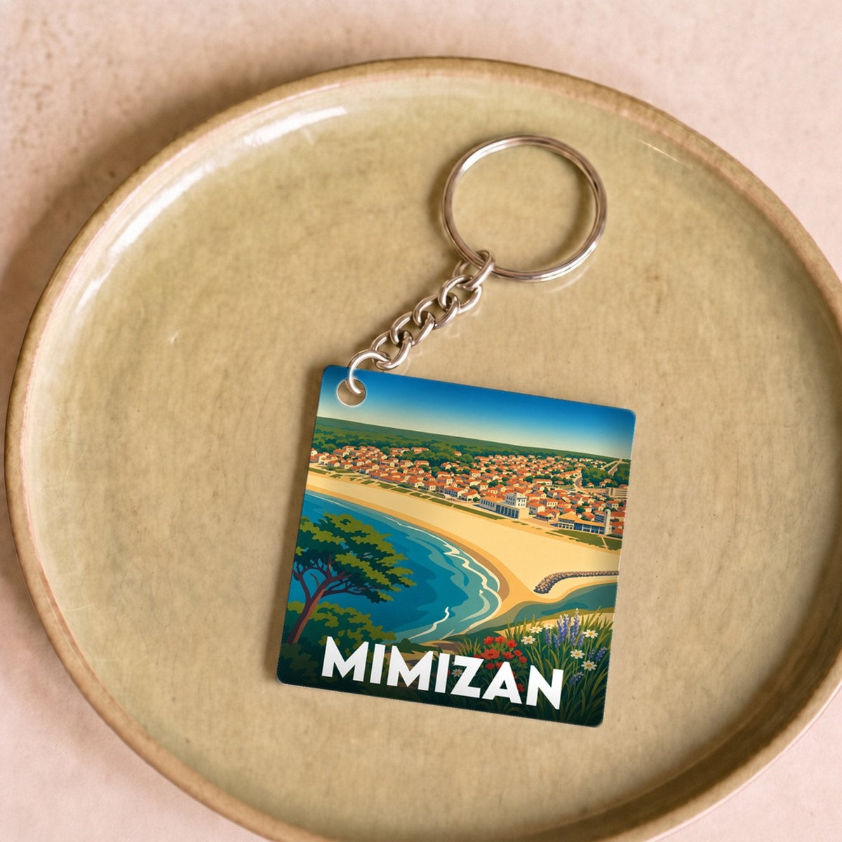 Porte-clés souvenir de la ville de Mimizan avec une illustration colorée de la côte landaise.