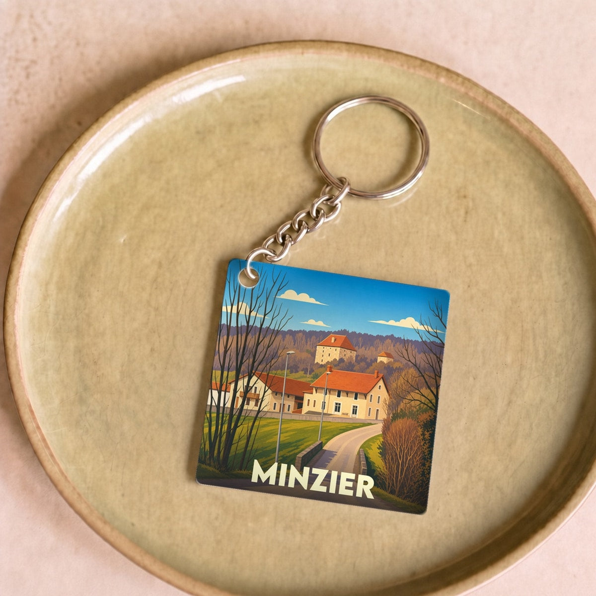 Porte-clés souvenir de la ville de Minzier avec une illustration stylisée.