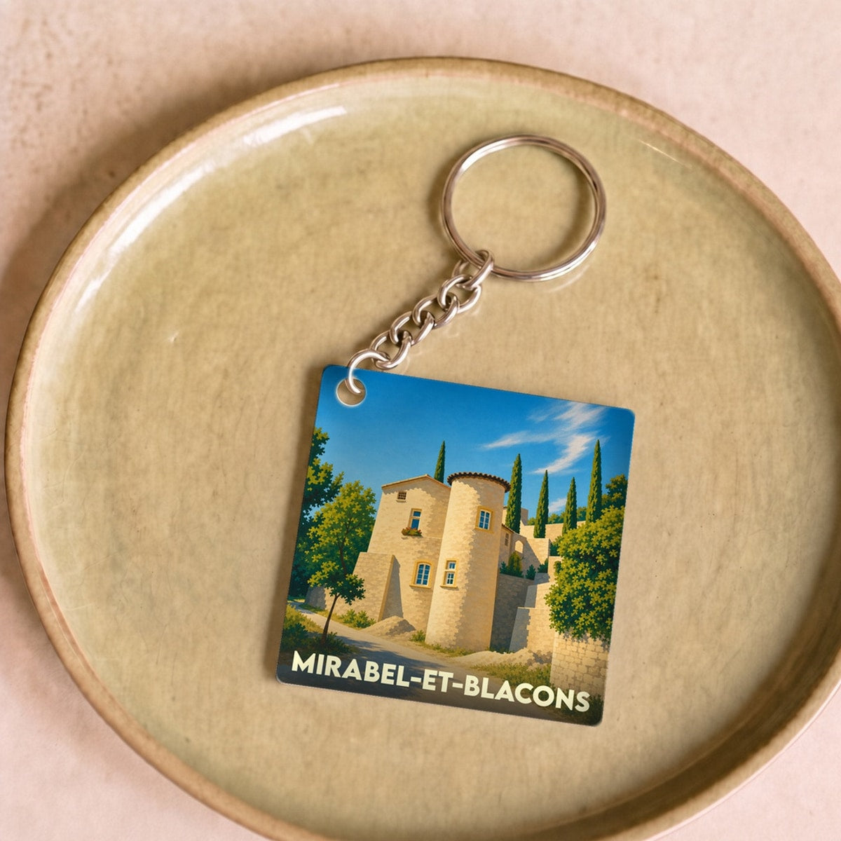 Porte-clés souvenir de la ville de Mirabel-et-Blacons avec une illustration stylisée.