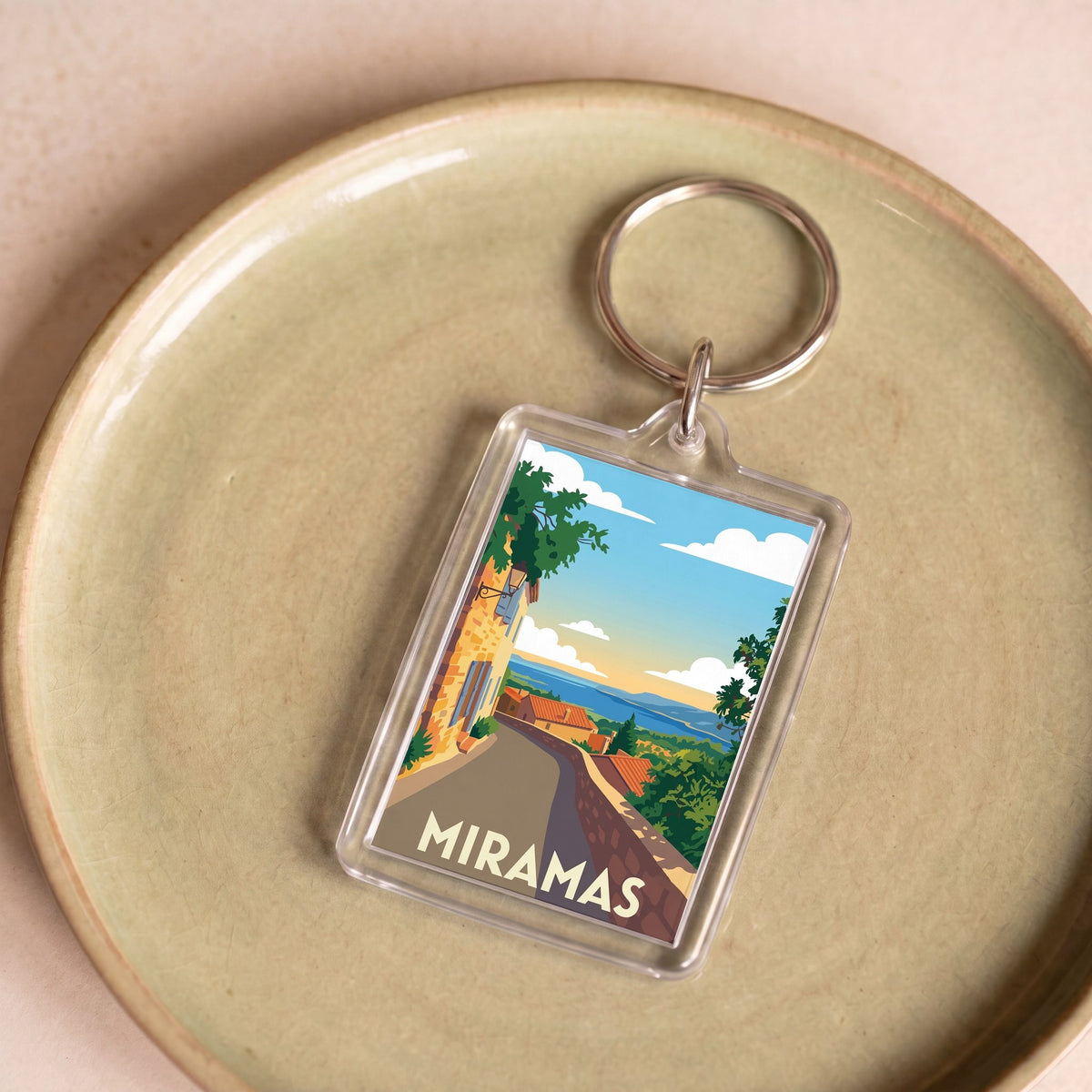 Porte-clés souvenir de la ville de Miramas avec une illustration stylisée.