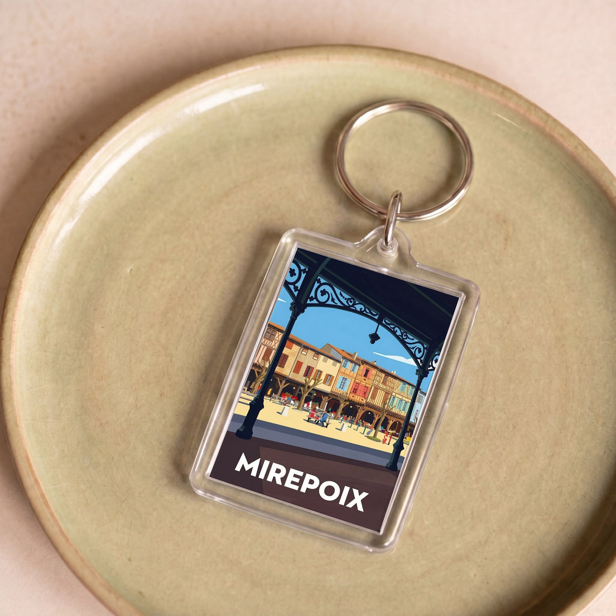 Porte-clés souvenir de la ville de Mirepoix avec une illustration stylisée.