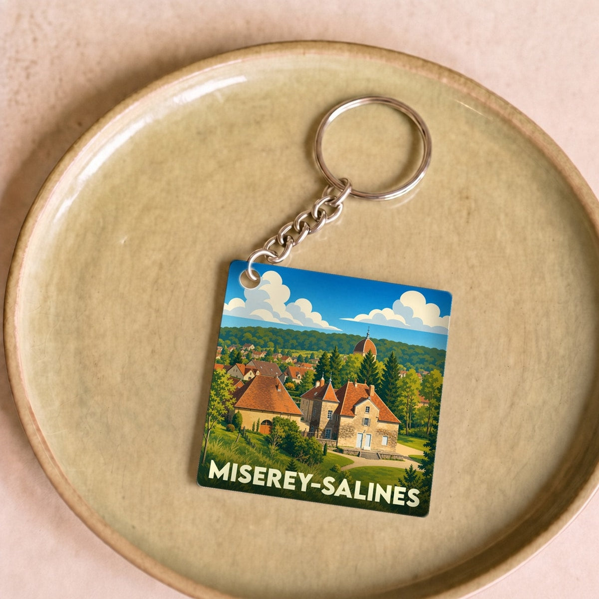 Porte-clés souvenir de la ville de Miserey-Salines avec une illustration stylisée.