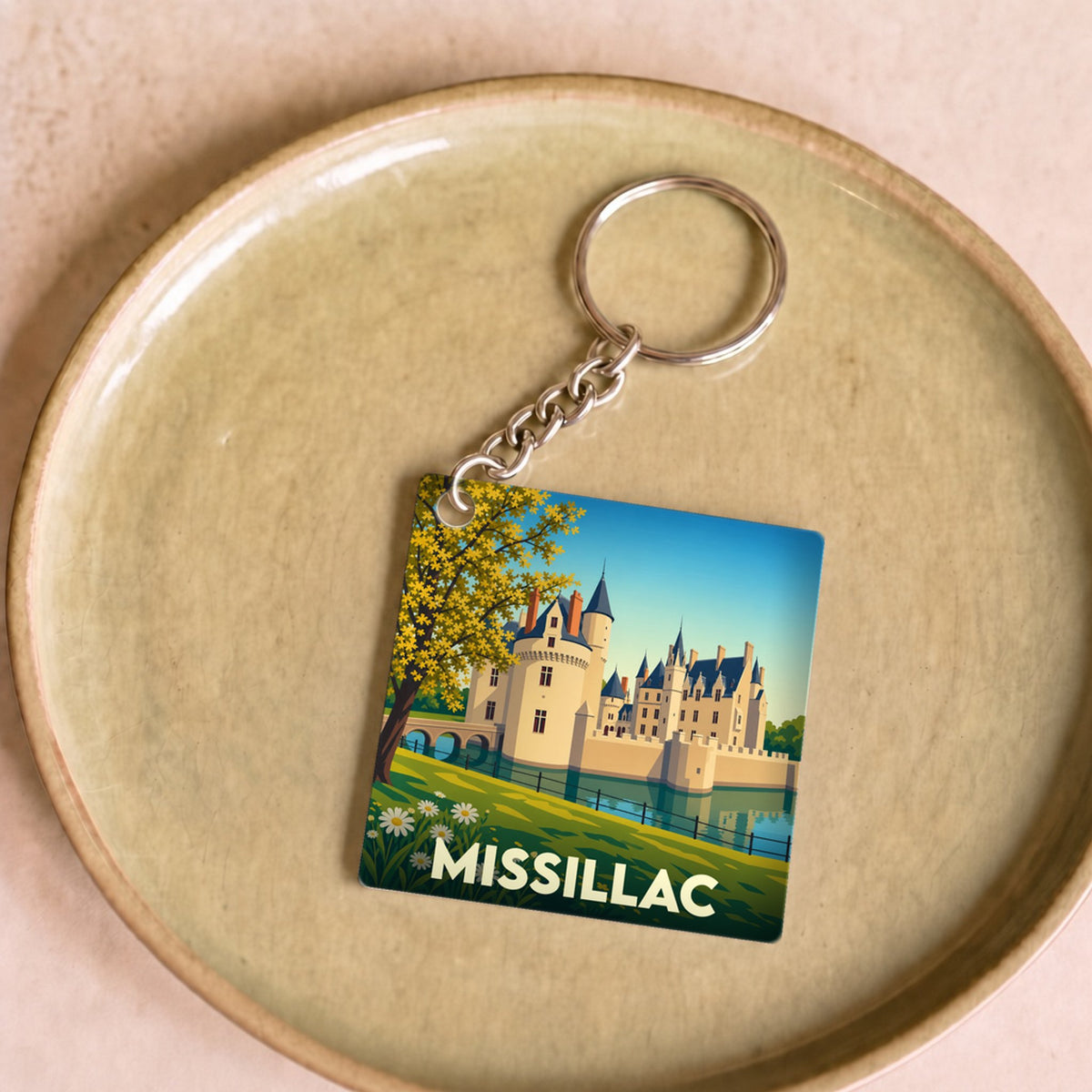 Porte-clés souvenir de la ville de Missillac avec une illustration stylisée de son château.