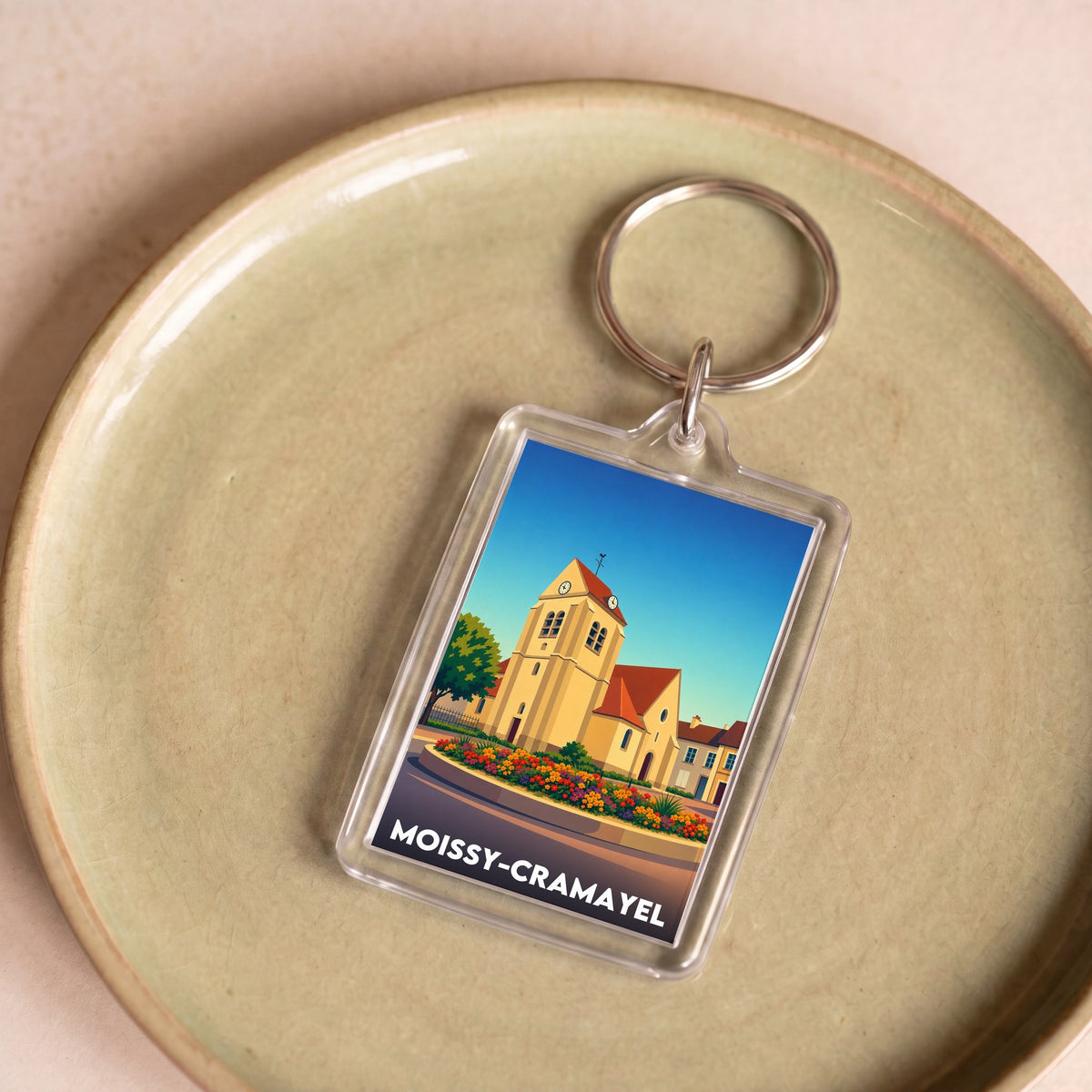 Porte-clés souvenir de la ville de Moissy-Cramayel avec une illustration stylisée.