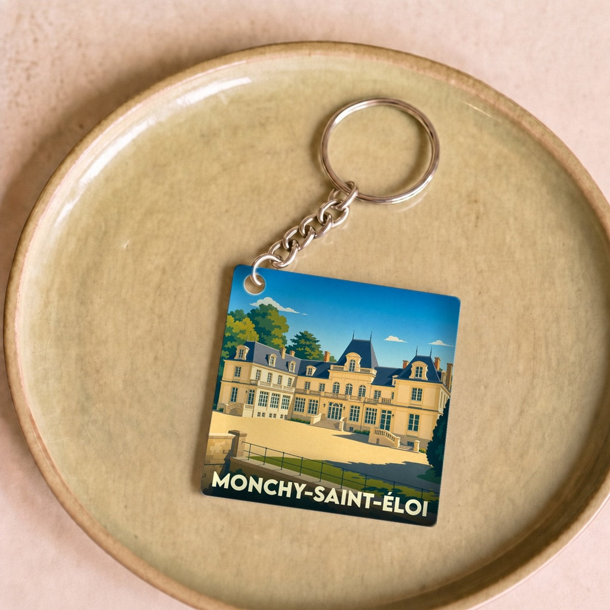 Porte-clés souvenir de la ville de Monchy-Saint-Éloi avec une illustration stylisée de son château.