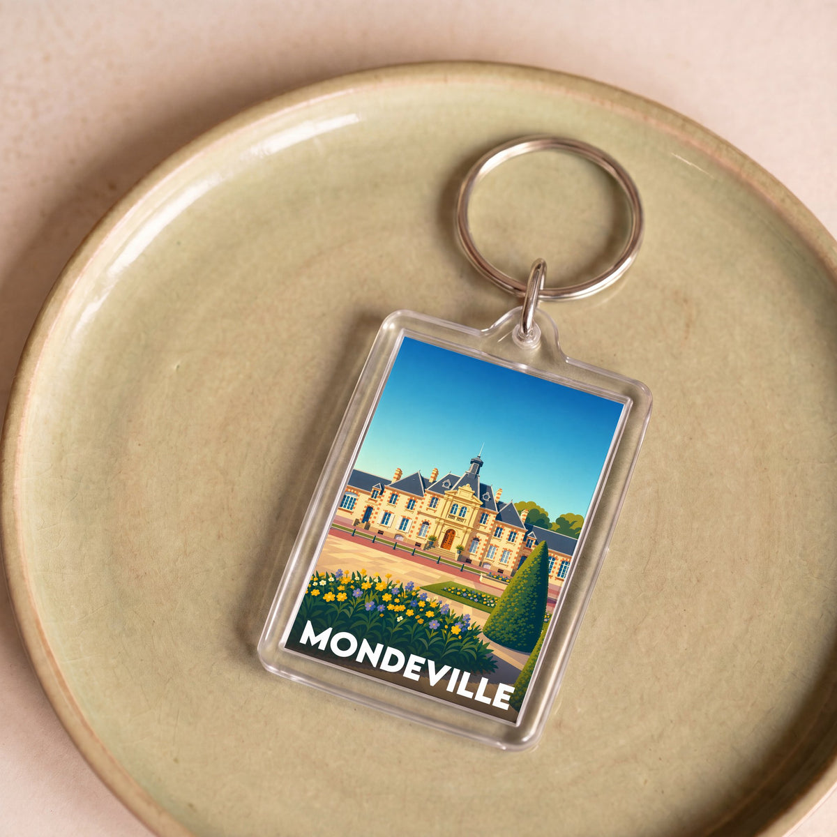 Porte-clés souvenir de la ville de Mondeville avec une illustration stylisée de l'hôtel de ville.