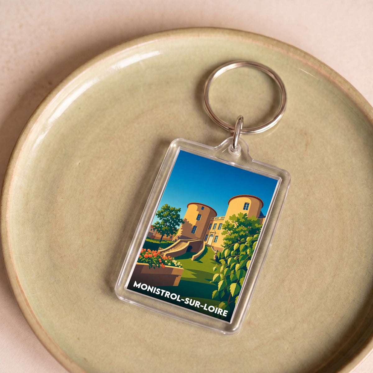 Porte-clés souvenir de la ville de Monistrol-sur-Loire avec une illustration stylisée de son patrimoine.