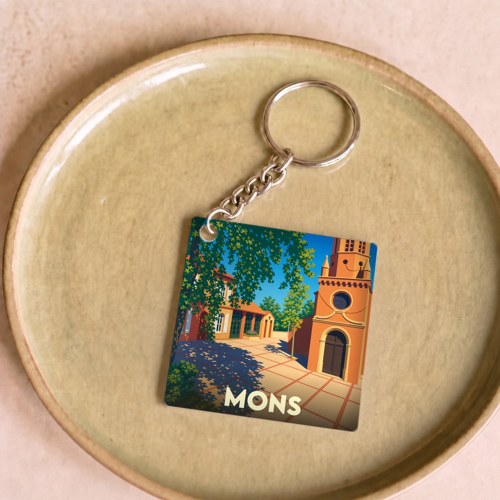 Porte-clés souvenir de la ville de Mons avec une illustration stylisée.