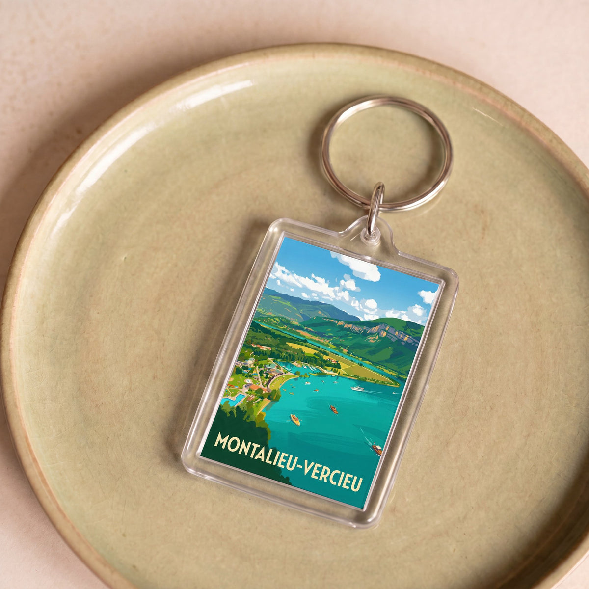 Porte-clés souvenir de la ville de Montalieu-Vercieu avec une illustration de paysage stylisée.