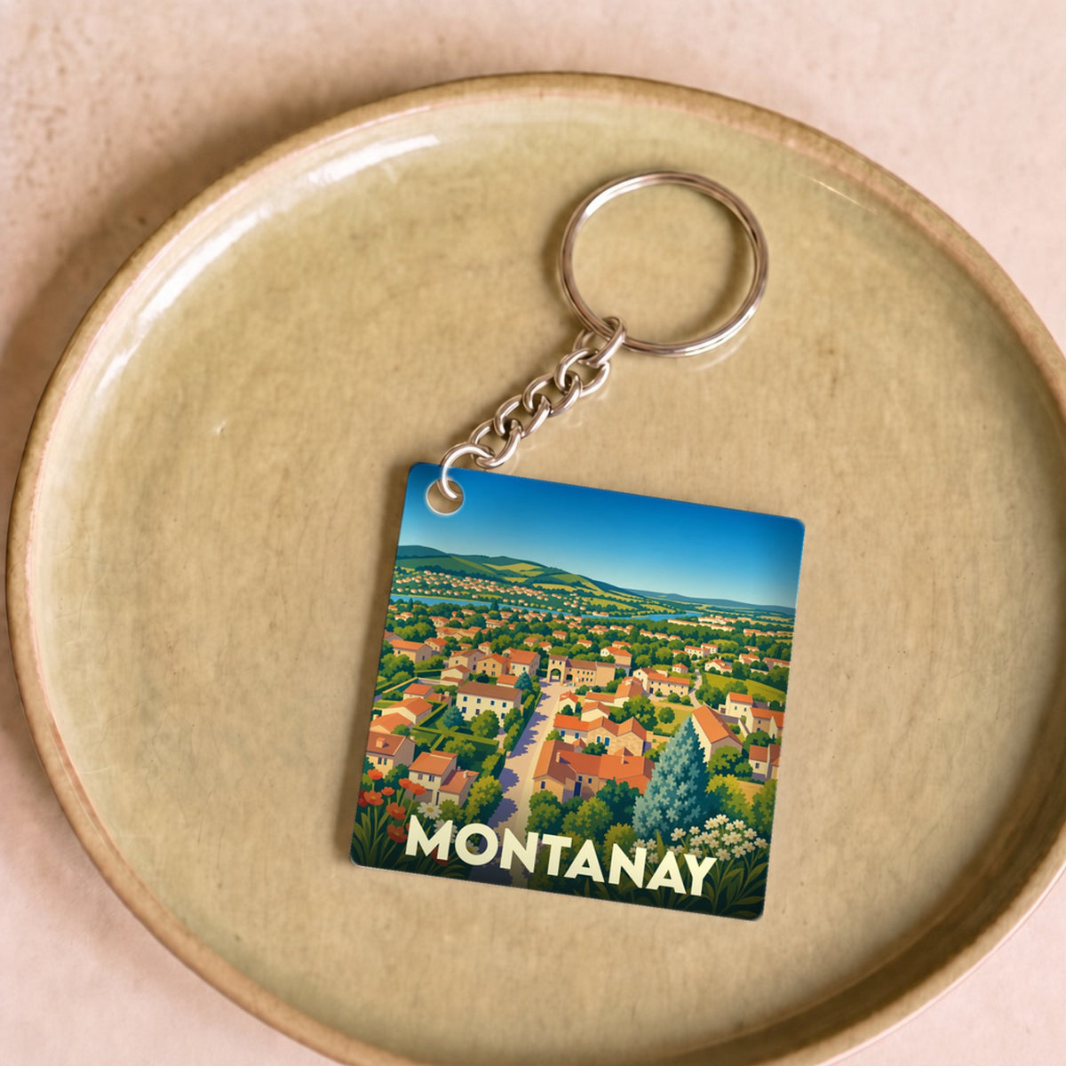 Porte-clés souvenir de la ville de Montanay avec une illustration stylisée.