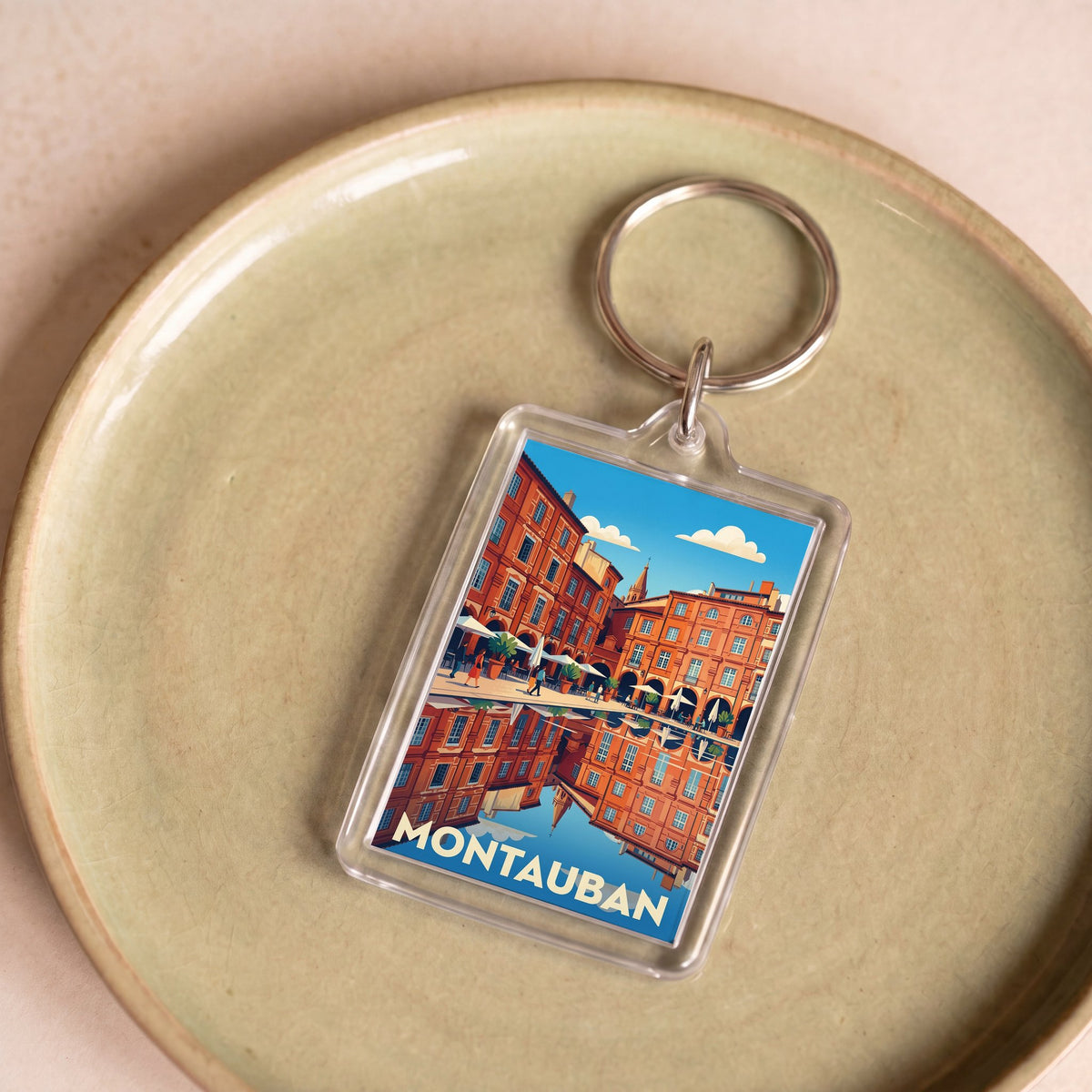Porte-clés souvenir de la ville de Montauban avec une illustration stylisée.